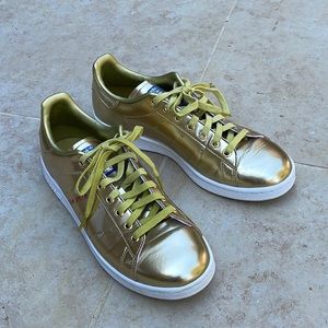 Adidas by Stan Smith metallic gold sneakers.